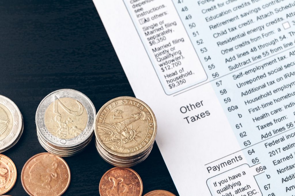 The close-up of accounting documents with money coins